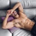 cute-shy-fit-shirtless-guy-smiling-laying-bed